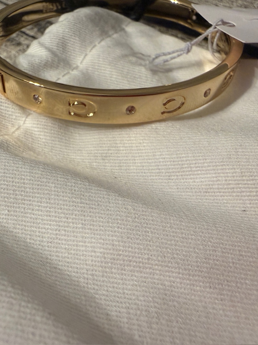NWT! Authentic Coach bangle bracelet in yellowgold, with “C” logos + dust bag!